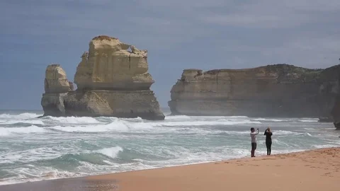 Tourists Walking Along Sandy Beach At Twelve Apostles Victoria Australia Stock Footage 80632762