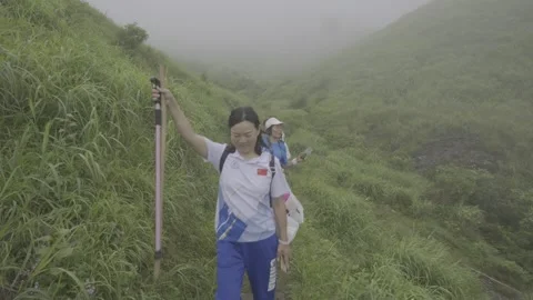 Tourists Walking on Alpine Meadow May 8 2026 Stock-Footage 343667250