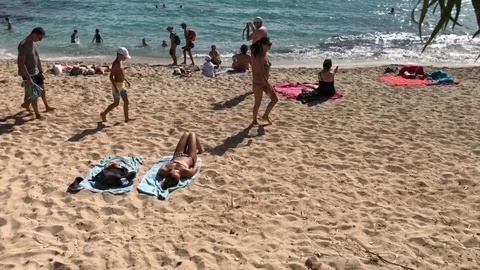 Tourists walking at the beach Stock Footage 91202306