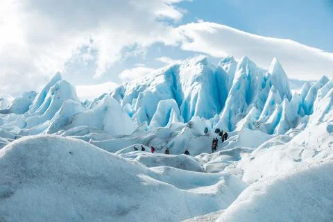 Tourists walking between the layers of ice formation of Perito Moreno Glacier Stock Photos