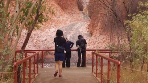 Tourists Walking On Boardwalk Path Along Uluru Ayers Rock Base In Northern Stock Footage 336108589
