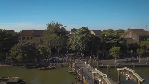Tourists walking on bridge over thu bon river in hoi an Stock Footage 329482059