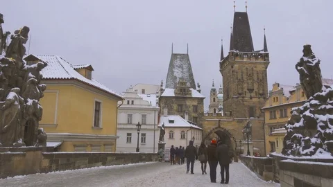 Tourists Walking on Charles Bridge Under the Snow Stock Footage 72145969