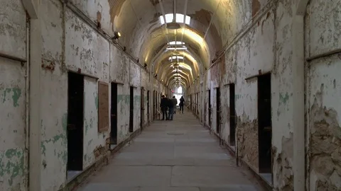 Tourists Walking Down Corridor at Historic Eastern State Penitentiary Stock Footage 100565655