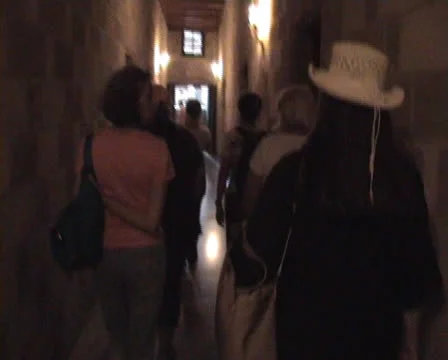 Tourists walking down a narrow passage in the Palace of the Grandmasters Stock Footage 22646191