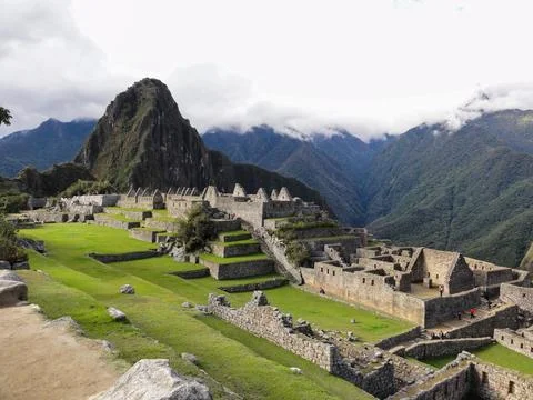 Tourists walking exploring inca trail ruins at machu picchu citadel Stock Photos
