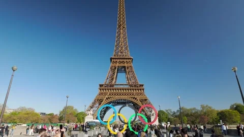 Tourists walking in front of the Eiffel Tower with Olympic rings, Paris is Stock Footage 315489525