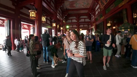 Tourists walking inside the famous Senso-ji Buddhist Temple in Asakusa, Tokyo Stock Footage 329882586