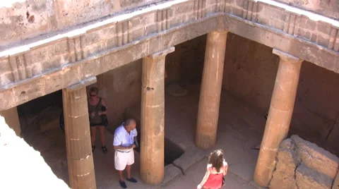 Tourists walking inside a tomb with columns in Paphos Stock Footage 39708485