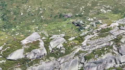 Tourists walking on a mountain path Stock Footage 300910912