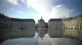 Tourists walking near mirror fountain at Place de la Bourse in Bordeaux, France HD Footage