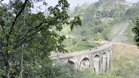 Tourists walking on Nine Arch Bridge in Ella Sri Lanka scenic railway viaduct Video stock 331706827
