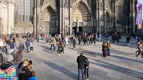 Tourists walking over the cathedral square in front of cologne cathedral Germany Stock Footage 87802980