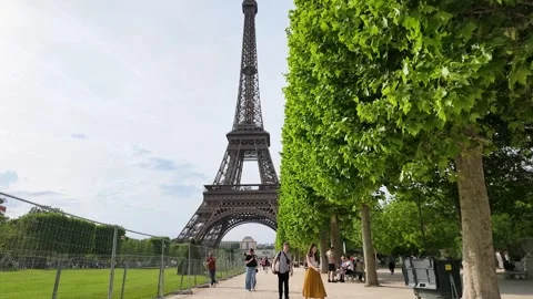 Tourists Walking on a Path Near the Eiffel Tower in Paris Stock Footage 334651784