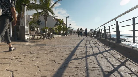 Tourists Walking On The Paved Seafront La Caleta Tenerife Spain Stock Footage 104394893