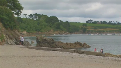 Tourists walking on Polgwidden Beach in Cornwall, UK Stock Footage 102474785
