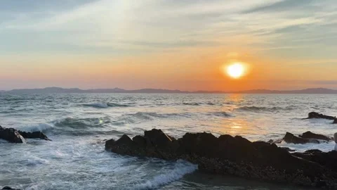 Tourists walking on romantic Van Chay beach under brilliant golden sunlight Stock Footage 327389208