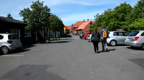 Tourists walking into small town Stock Footage 38440048