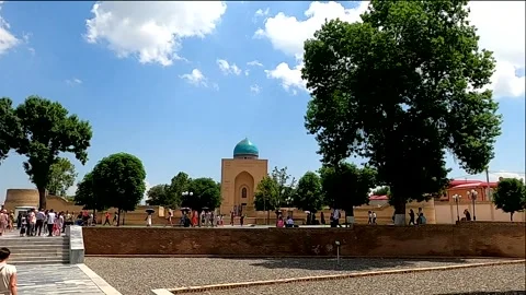 Tourists walking in the square by Bibi-Khanym Mausoleum in Samarkand Stock Footage 336846208