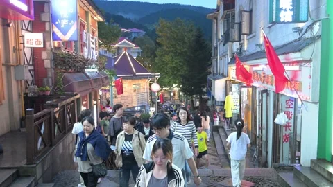 Tourists Walking on Steps Street Lined with Red Flags, Guling Lushan Stock Footage 346701255