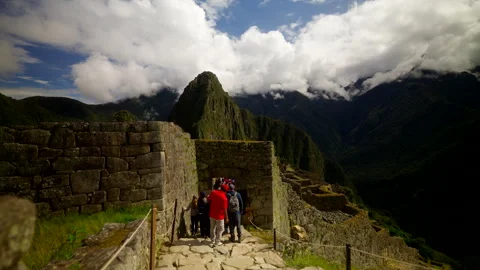 Tourists Walking Stone Path Through Machu Picchu Ruins Stock Footage 328211826
