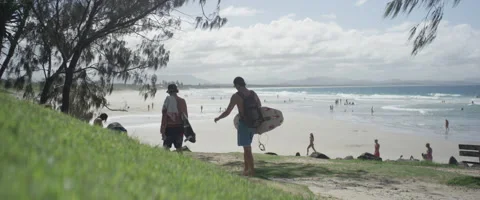 Tourists walking with surfboard on beach Stock Footage 67020439