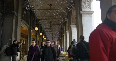 Tourists walking through archways at St. Mark's Square during Venice Carnival. Stock Footage 151963612