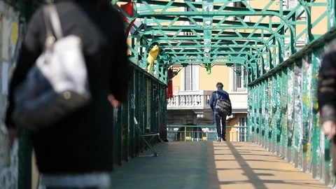 Tourists walking through footbridge in slow motion Stock Footage 89975005