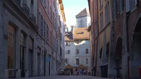 Tourists walking through historical centre of city, castle tower in backgroun Video stock 157007629