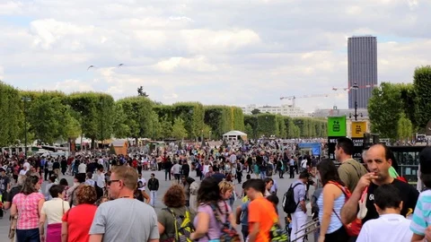 Tourists walking under the Eiffel Tower in Paris France Stock Footage 105520922