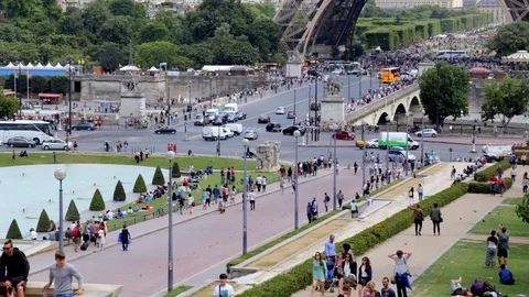 Tourists walking under the Eiffel Tower in Paris France Stock Footage 105521330