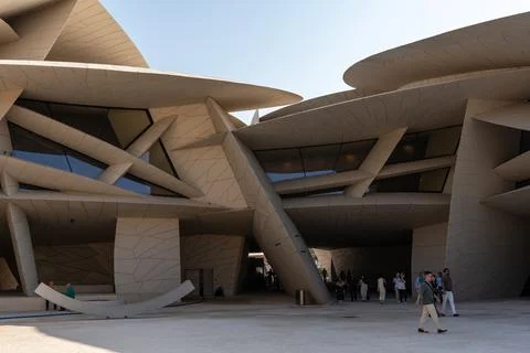 Tourists walking under interlocking discs of desert rose architecture at NMOQ. Stock Photos