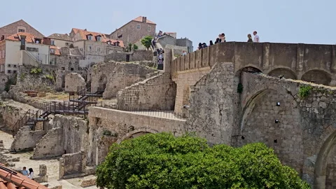 Tourists walking wall surrounding Old Town Dubrovnik Stock Footage 294287660