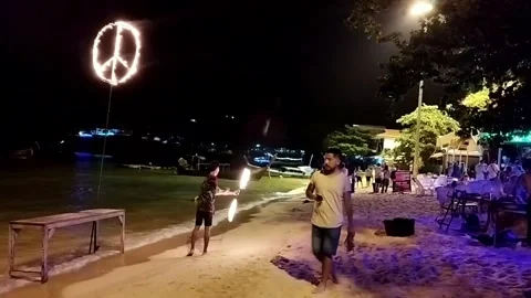 Tourists Watching Beach Fire Show and Burning Peace Sign in Phi Phi Island Stock Footage 343205738