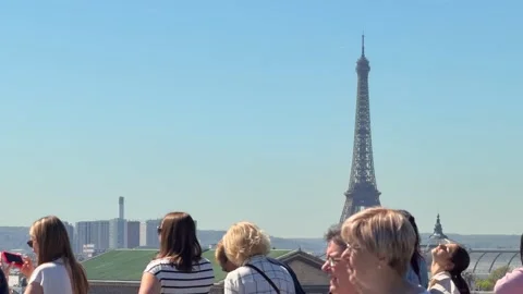 Tourists watching the Eiffel Tower from a viewpoint in Paris, France Stock Footage 337783134