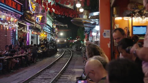 Tourists Watching Train Passing Through Narrow Hanoi Train Street. Stock Footage 323765745