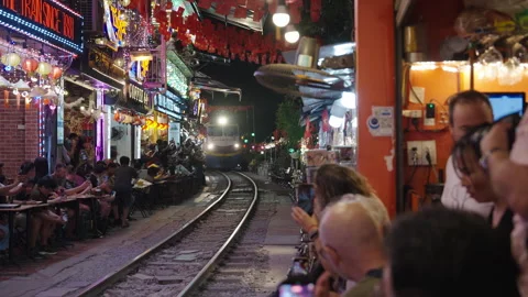 Tourists Watching Train Passing Through Narrow Hanoi Train Street. Stock Footage 323771626