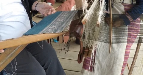 Tourists weaving silk in Weaving Class Stock Footage 90664543