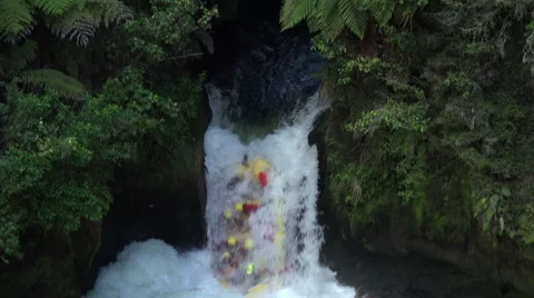Tourists white water rafting down waterfall, Rotorua, New Zealand Stock Footage