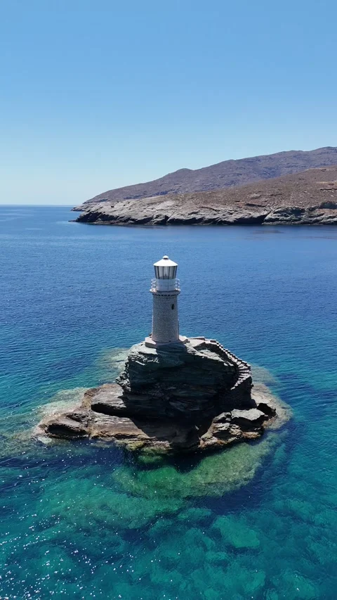 Tourlitis Lighthouse on rocky sea stack off Andros Chora, Andros Island Stock Footage 325834926