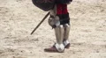 Tournament rivals in steel armor fighting with swords, defending with shields HD Footage