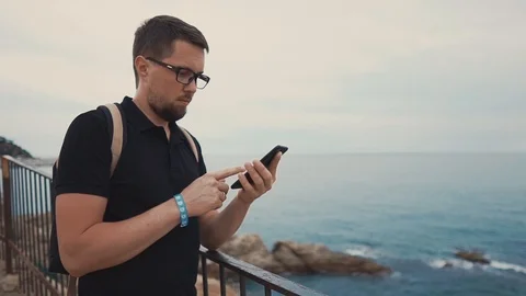 Toursit with smartphone on the shore. Stock Footage 100123558