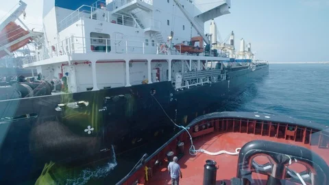 A tow ship connects to the ship 1 Stock Footage 118591847