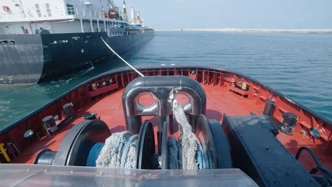 A tow ship connects to the ship Stock Footage 118592081