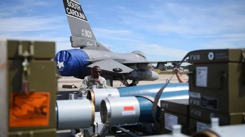 Tow tractor moving with weapons, assembling weapons in aircraft - 2017 Stock Footage 84730401