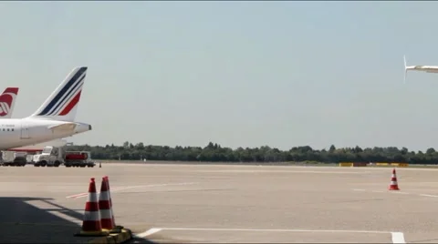 Tow Tractor pulling Jet Airplane and taxiing On Dusseldorf Airport. Stock Footage 41375240