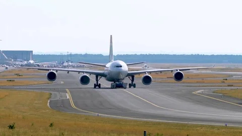 Tow Tractor towing a passenger plane on the runway of the airfield Stock Footage 79062970