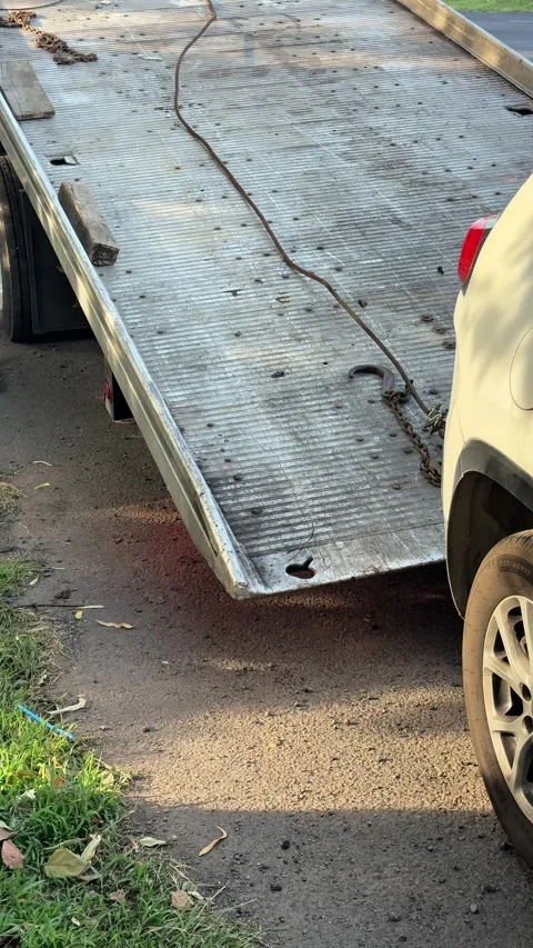 Tow truck flatbed moving into position to load a car Stock Footage 340230268
