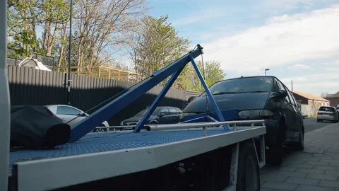 A tow  truck is pulling a car. Video stock 88733845