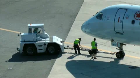 Tow tug ground crew detach Airplane towbar Stock Footage